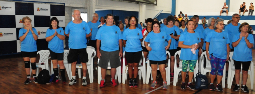 Idosos posando para a foto vestidos com a camiseta do evento